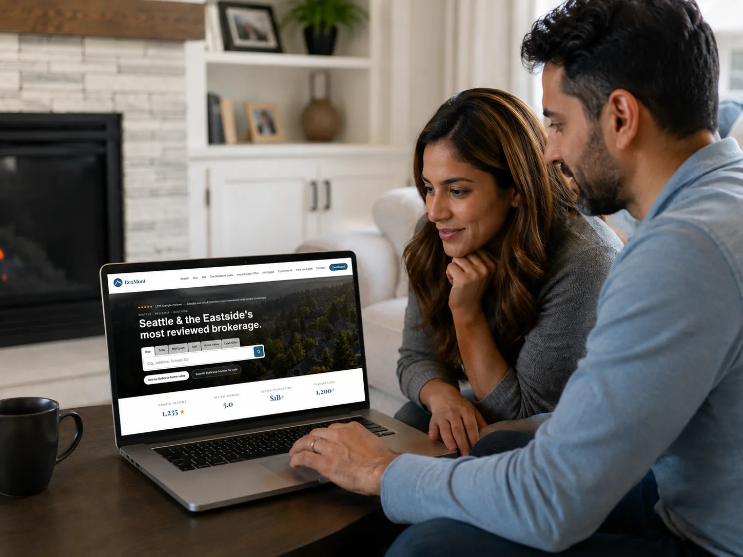Couple reviewing the Seattle and Eastside real estate market on the RexMont website from their living room